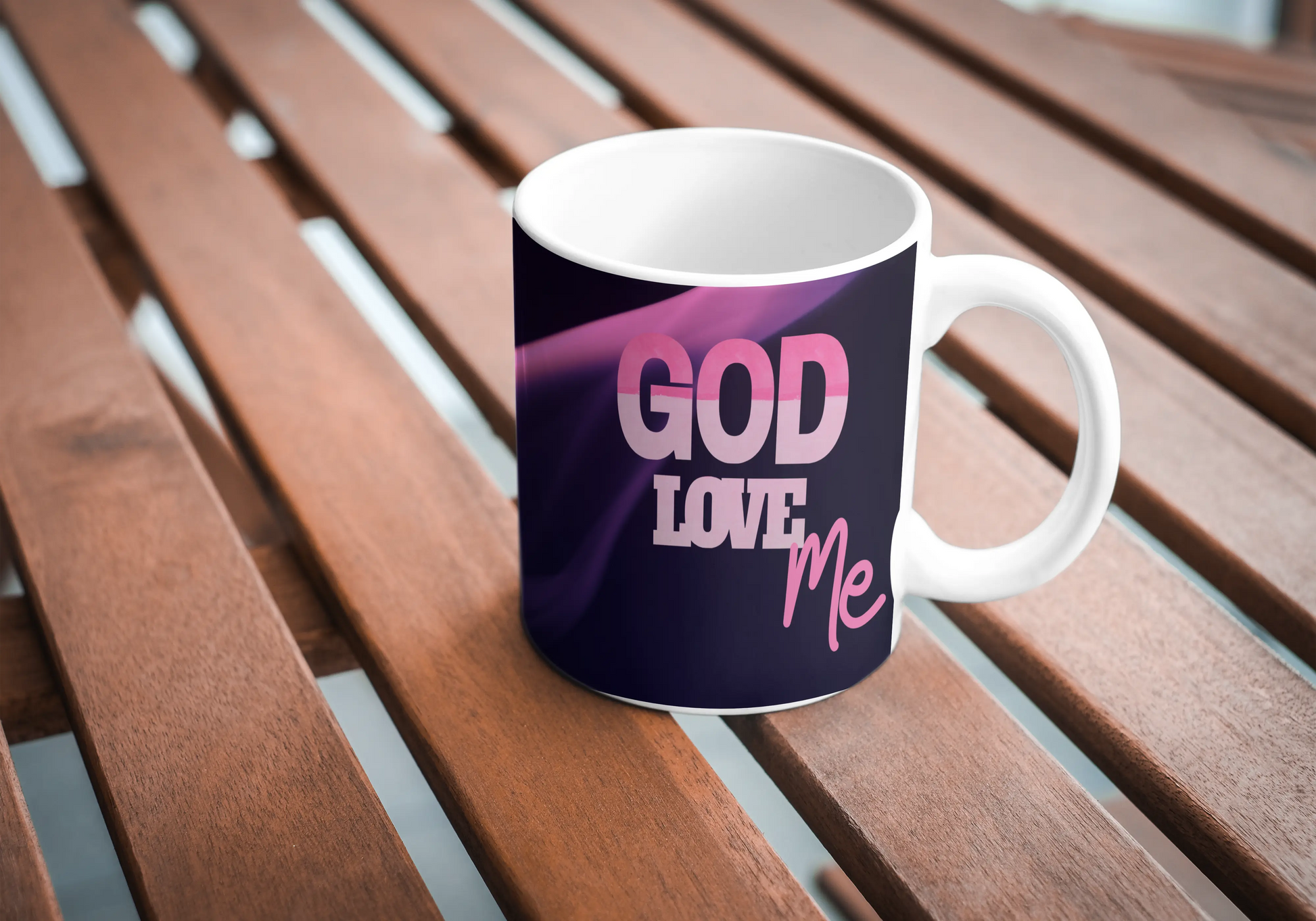 Mug with 'GOD LOVE ME' text on a wooden surface